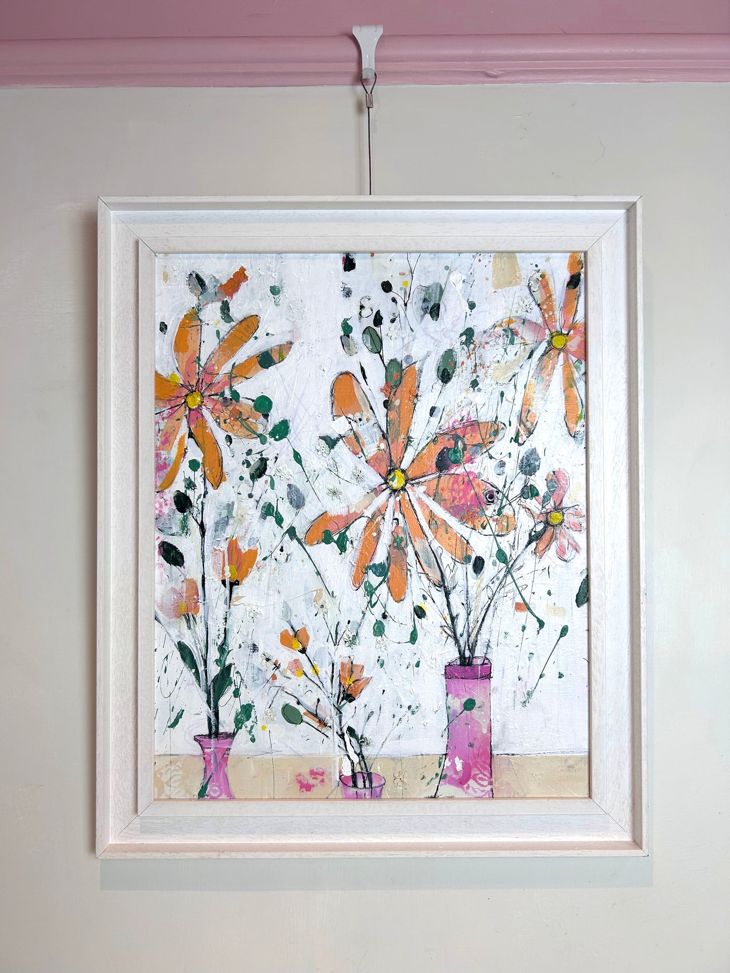 Orange flowers in pink vases